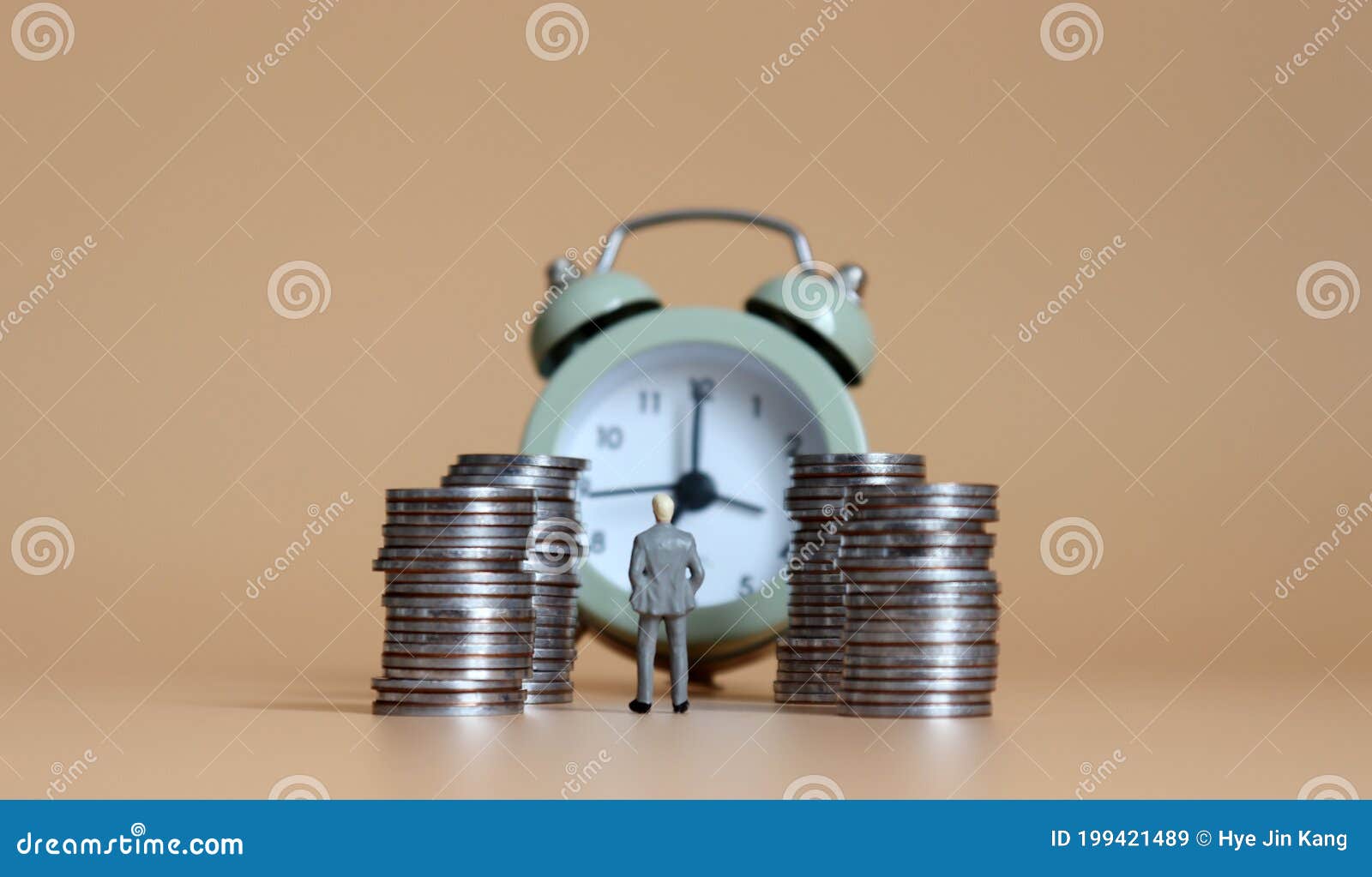 miniature people with an alarm clock and a pile of coins.